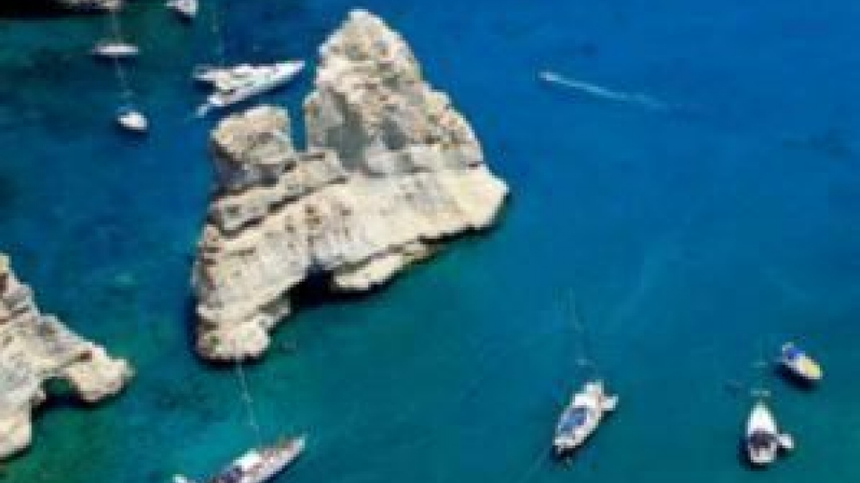 Kleftiko in Milos attracts thousands of visitors every year who enjoy the crystal-clear waters by the impressive white cliffs.